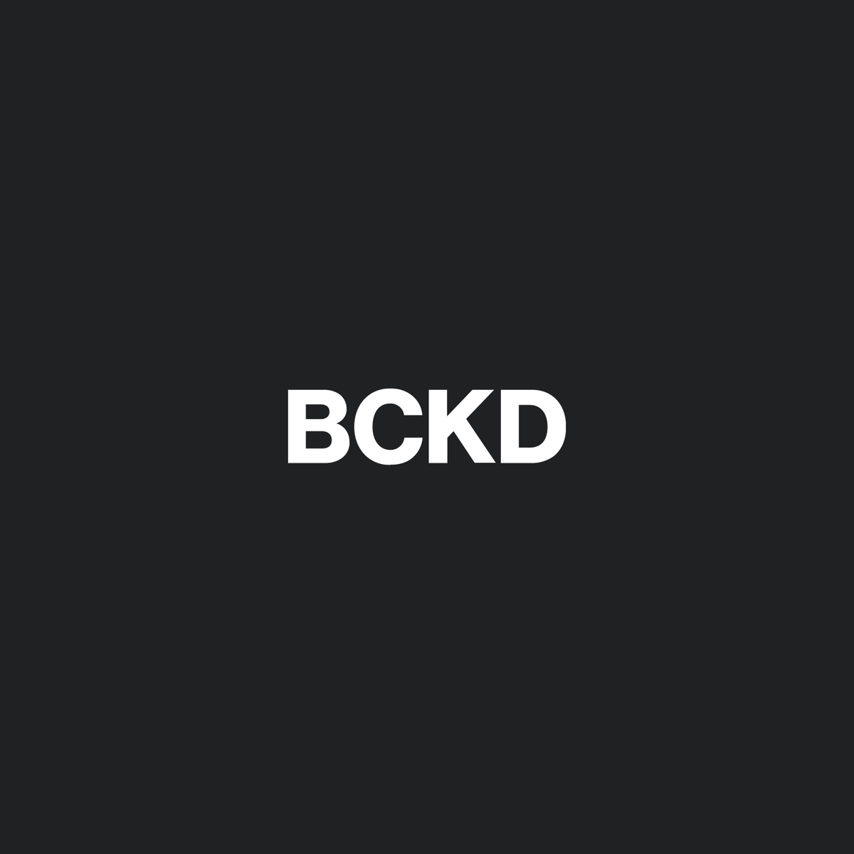 Backed Studios minimal white BCKD logo on a dark grey background.