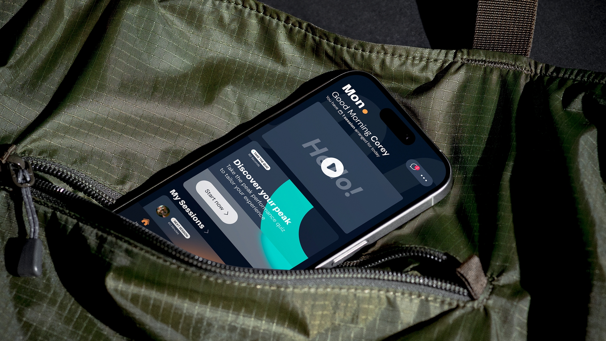 MindReady App dashboard screen displayed on an iPhone that is popping out from the pocket of a green sports bag.